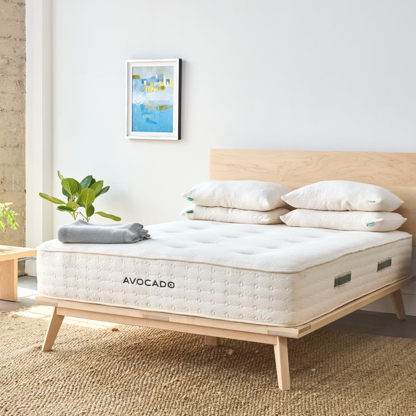 Avocado Green hybrid mattress styled with bedding in a bedroom
