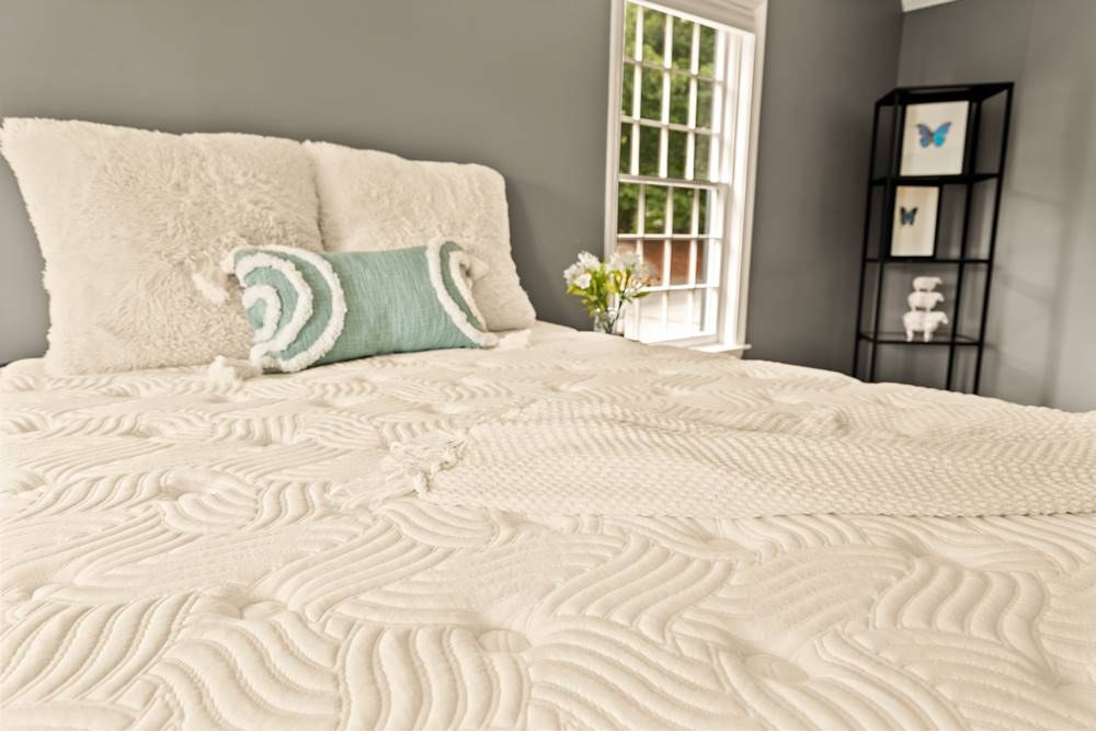 DLX Premier Hybrid (Medium) mattress styled in a bedroom