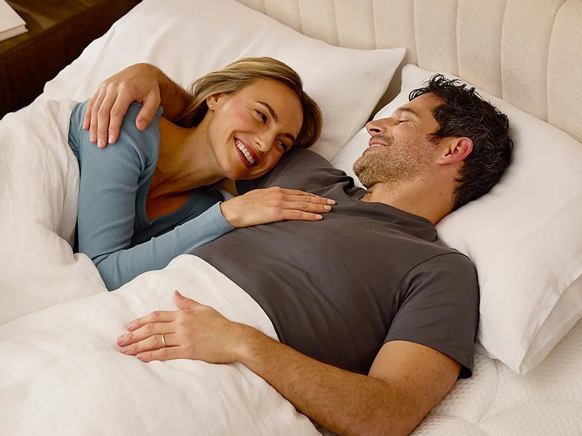 DreamCloud Premier Hybrid mattress styled with bedding in a bedroom