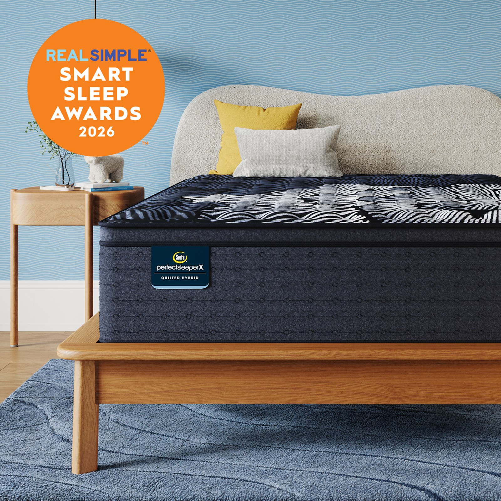 Serta Perfect Sleeper X Quilted Hybrid Level Two mattress styled in a bedroom