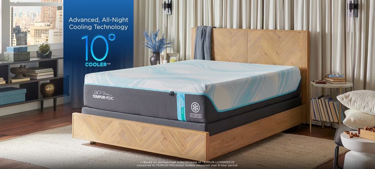 TEMPUR-LUXEbreeze mattress styled on a wooden bed frame in a bedroom