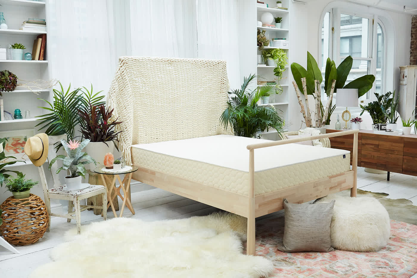 The WinkBed luxury hybrid mattress styled in a bright bedroom